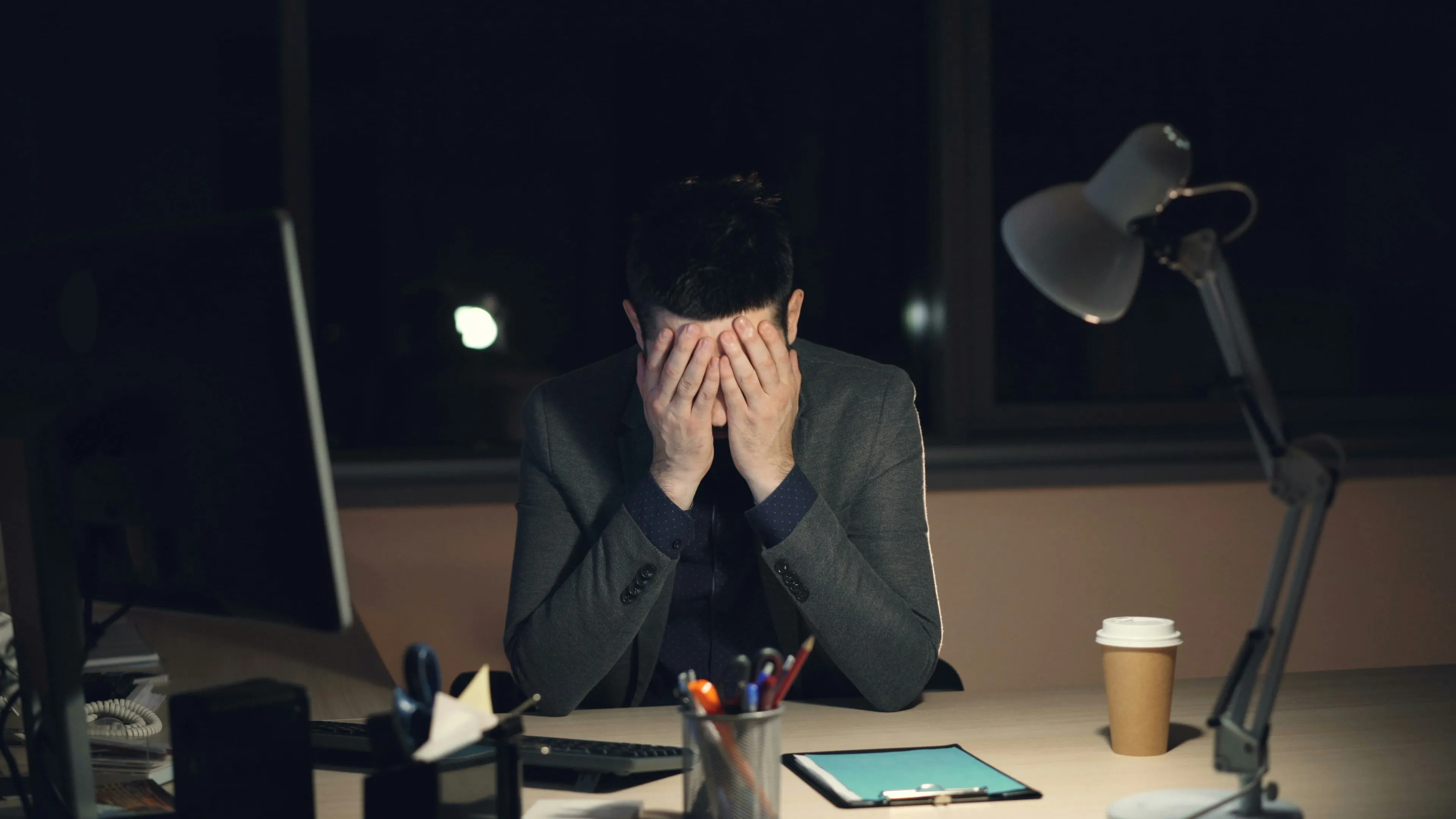 Person looking stressed while working at computer